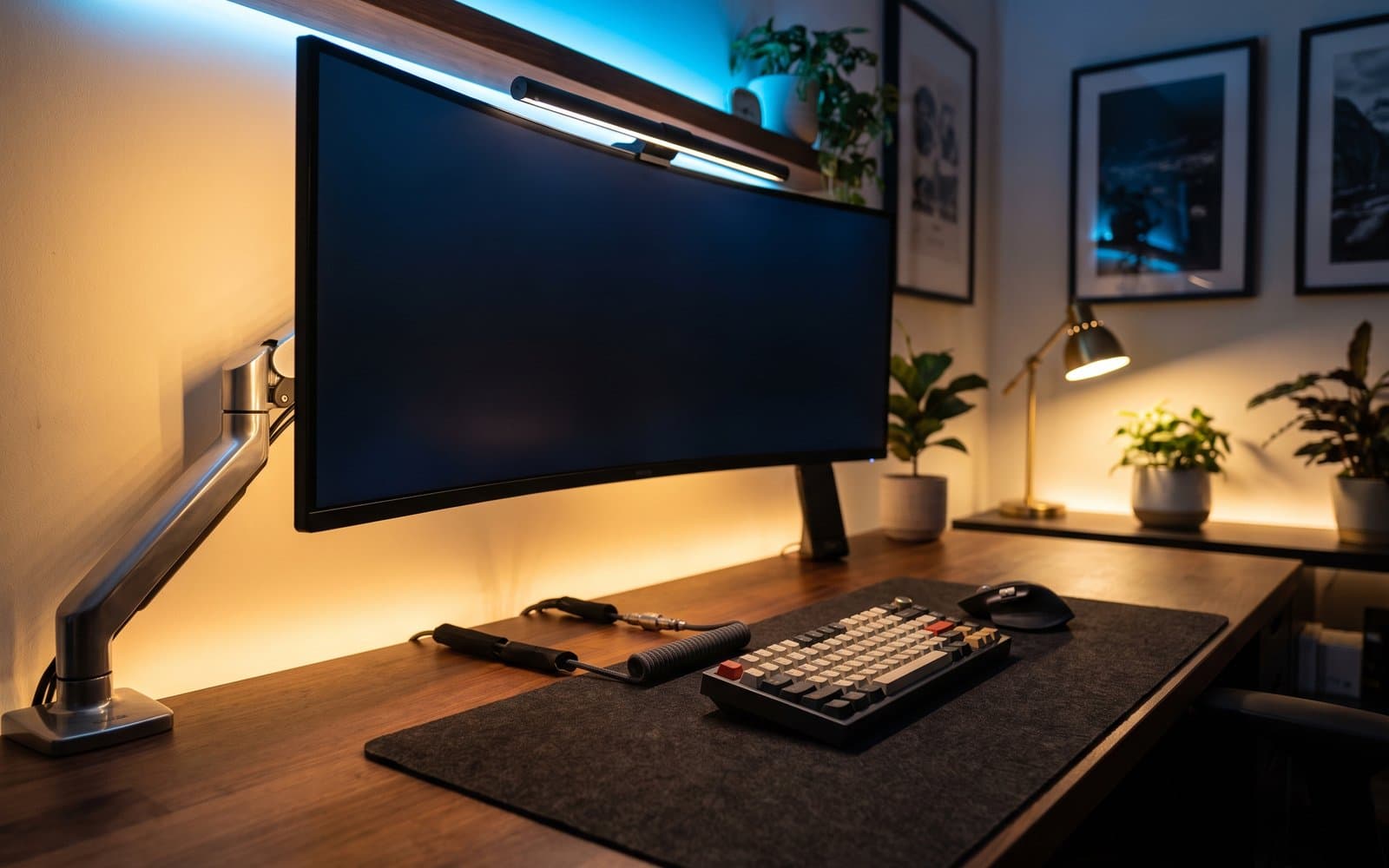 Premium desk setup with an ultrawide monitor, warm bias lighting, and clean cable management