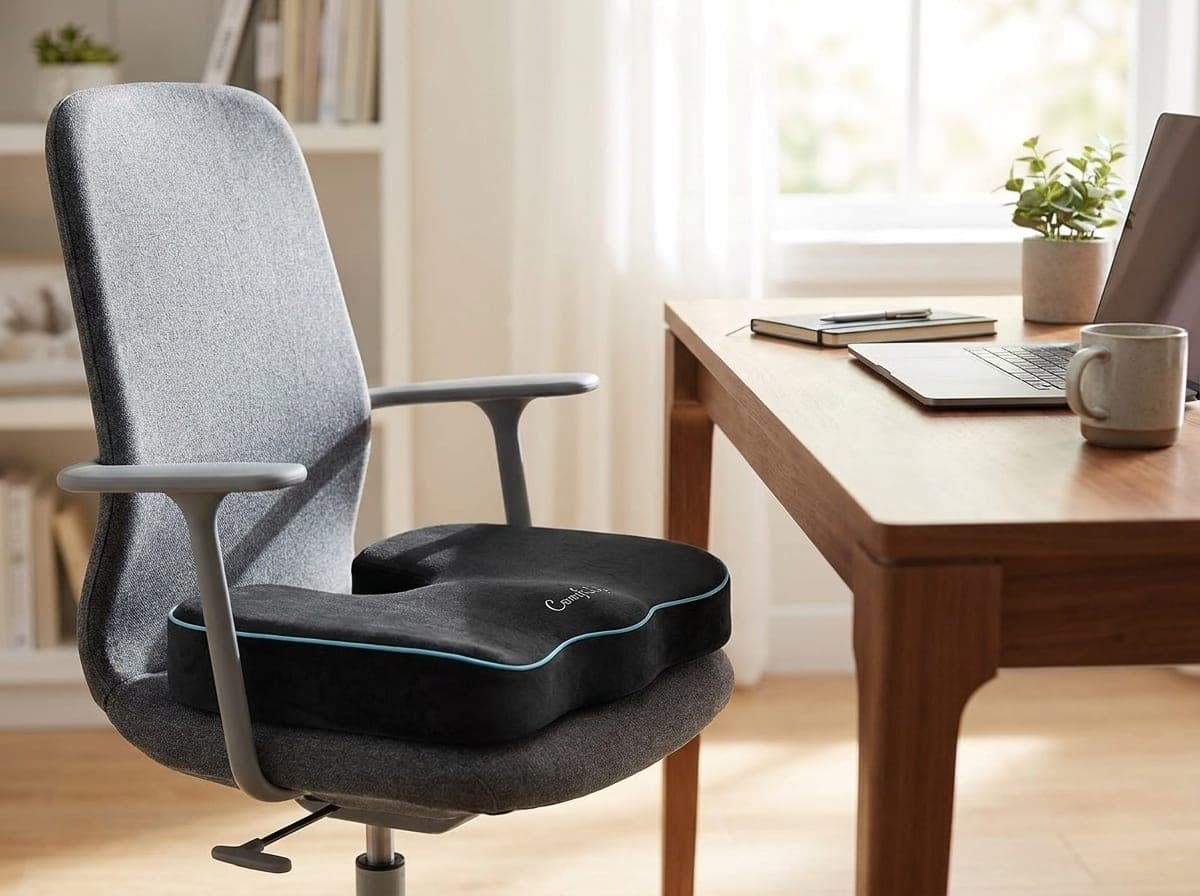 ComfiLife gel-enhanced memory foam seat cushion with a U-shaped rear tailbone cutout sitting on an ergonomic office chair in a home office