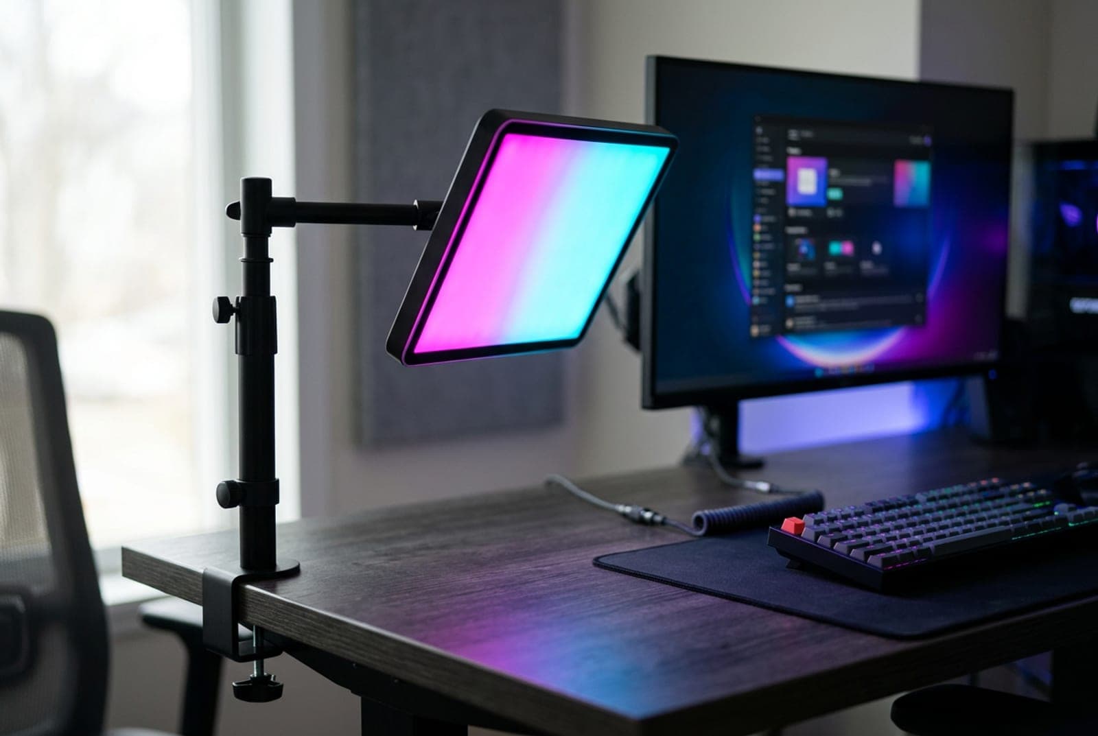 Razer Key Light Chroma RGB edge-lit panel on a clamp-mounted extendable pole at a streaming desk